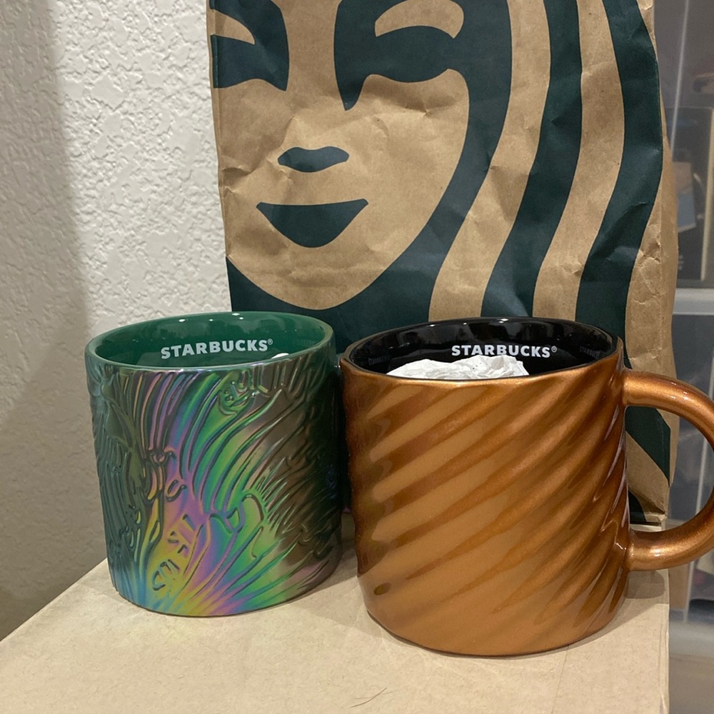 Two chrome Starbucks mugs